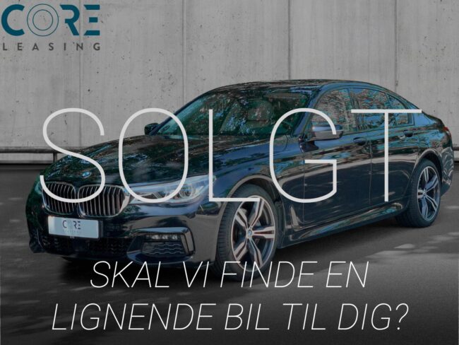 Sortmetal BMW 740d xDrive aut. fra 2016 parkeret foran en betonmur. CORE Leasing A/S er eksperter i BMW leasing.