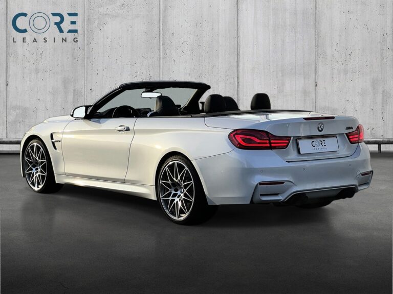 Hvidmetal BMW M4 Cabriolet Competition aut. fra 2018 parkeret foran en betonmur. CORE Leasing A/S er eksperter i BMW leasing.