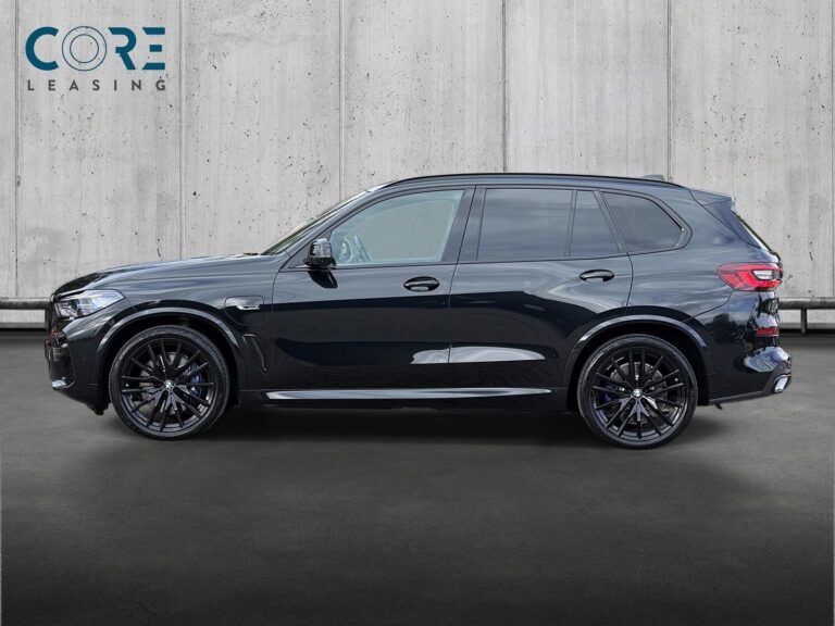 Sortmetal BMW X5 xDrive45e M-Sport aut. fra 2023 parkeret foran en betonmur. CORE Leasing A/S er eksperter i BMW leasing.