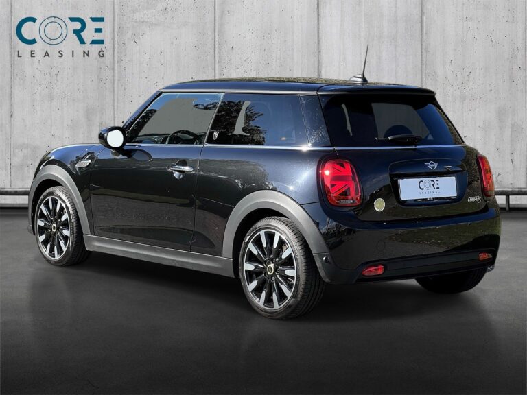 Sortmetal MINI Cooper SE Maximise fra 2022 parkeret foran en betonmur. CORE Leasing A/S er eksperter i MINI leasing.