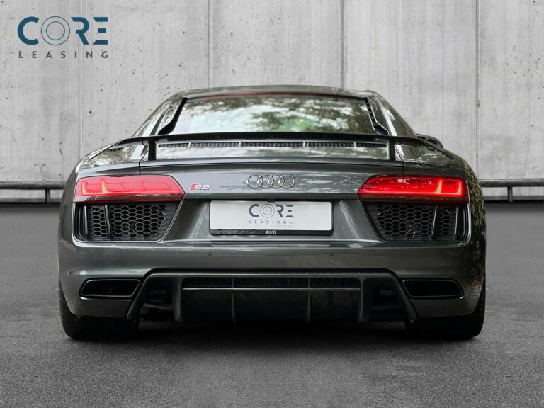 Gråmetal Audi R8 FSi Plus Coupé quattro S-tr. fra 2016 parkeret foran en betonmur. CORE Leasing A/S er eksperter i Audi leasing.