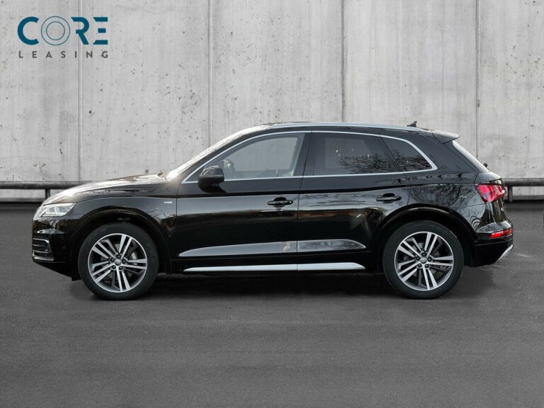 Sortmetal Audi Q5 TDi 190 S-line quattro S-tr. fra 2017 parkeret foran en betonmur. CORE Leasing A/S er eksperter i Audi leasing.