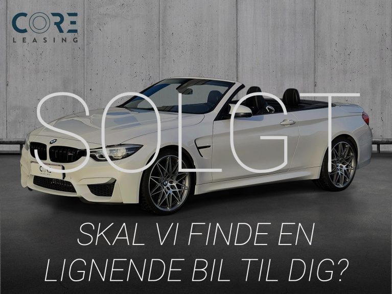 Hvidmetal BMW M4 Cabriolet Competition aut. fra 2018 parkeret foran en betonmur. CORE Leasing A/S er eksperter i BMW leasing.