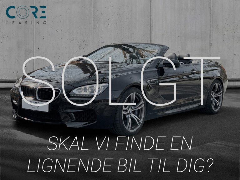 Sortmetal BMW M6 Cabriolet aut. fra 2013 parkeret foran en betonmur. CORE Leasing A/S er eksperter i BMW leasing.