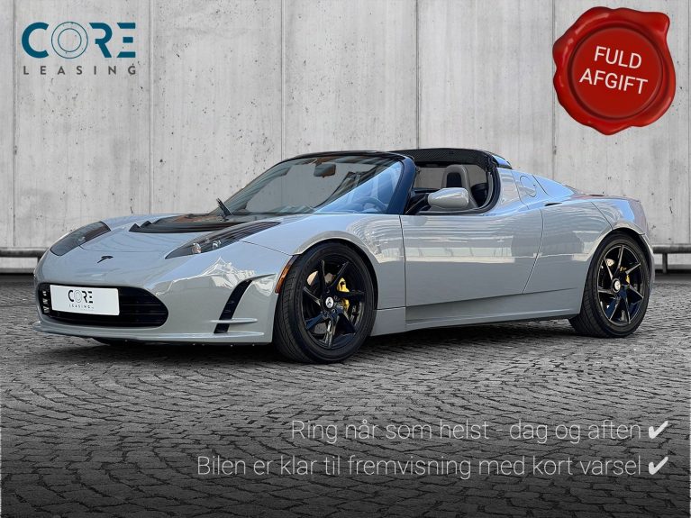 Gråmetal Tesla Roadster  fra 2010 parkeret foran en betonmur. CORE Leasing A/S er eksperter i Tesla leasing.