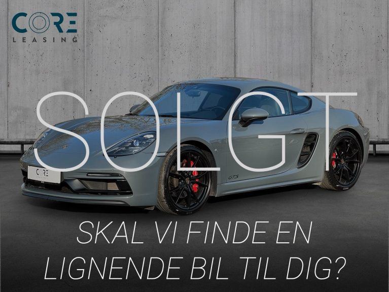 Gråmetal Porsche 718 Cayman GTS PDK fra 2018 parkeret foran en betonmur. CORE Leasing A/S er eksperter i Porsche leasing.