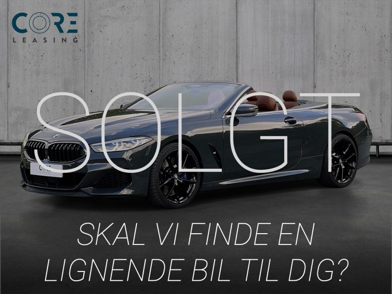 Gråmetal BMW M850i Cabriolet xDrive aut. fra 2019 parkeret foran en betonmur. CORE Leasing A/S er eksperter i BMW leasing.